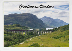 Steam train crossing the Glenfinnan Viaduct over a green valley with mountains in the distance. British Railways, LNER, ScotRail, The Jacobite Steam Train service, Glenfinnan Viaduct, Harry Potter, Hogwarts Express steam train, Fort William, Mallaig, Scottish Highlands, Loch Shiel, Steam trains, Golden Age of Steam